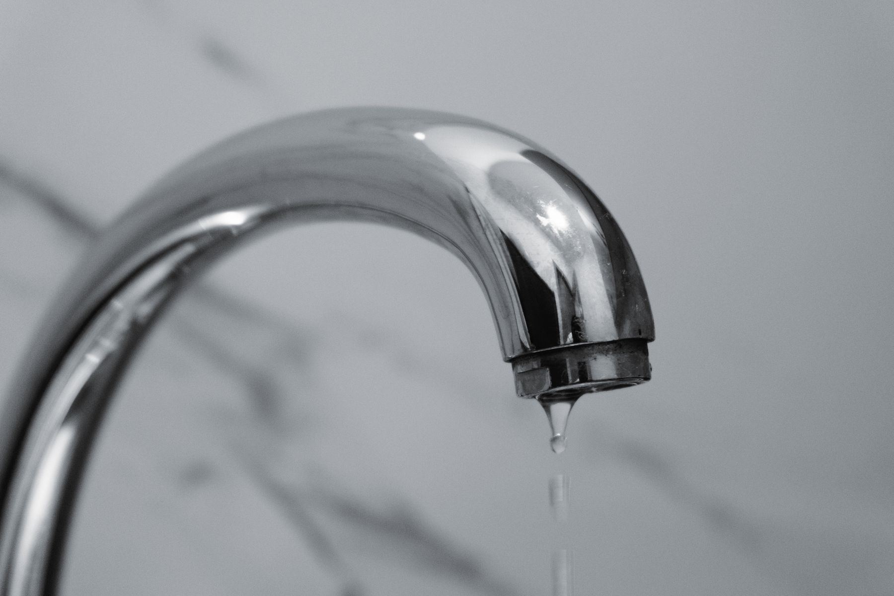 Reference photo of a faucet with a drop of water, not this company's work